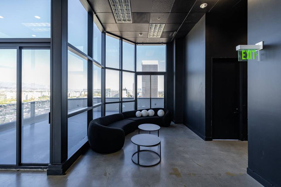 Interior lounge at Skyla with city views through glass walls