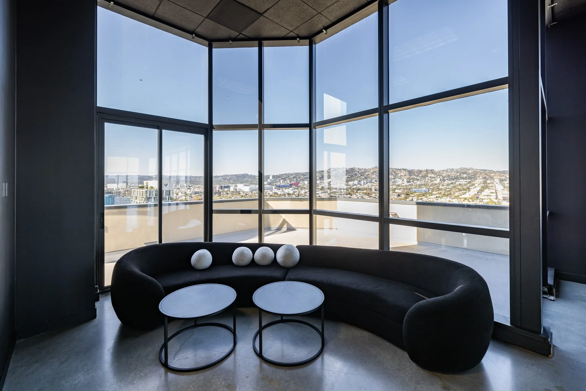 Curved lounge seating with panoramic city views at Skyla